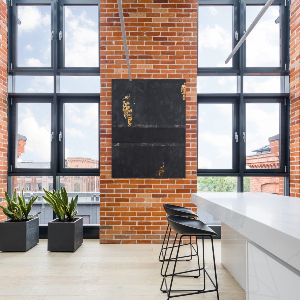 Kitchen with big windows and brick walls