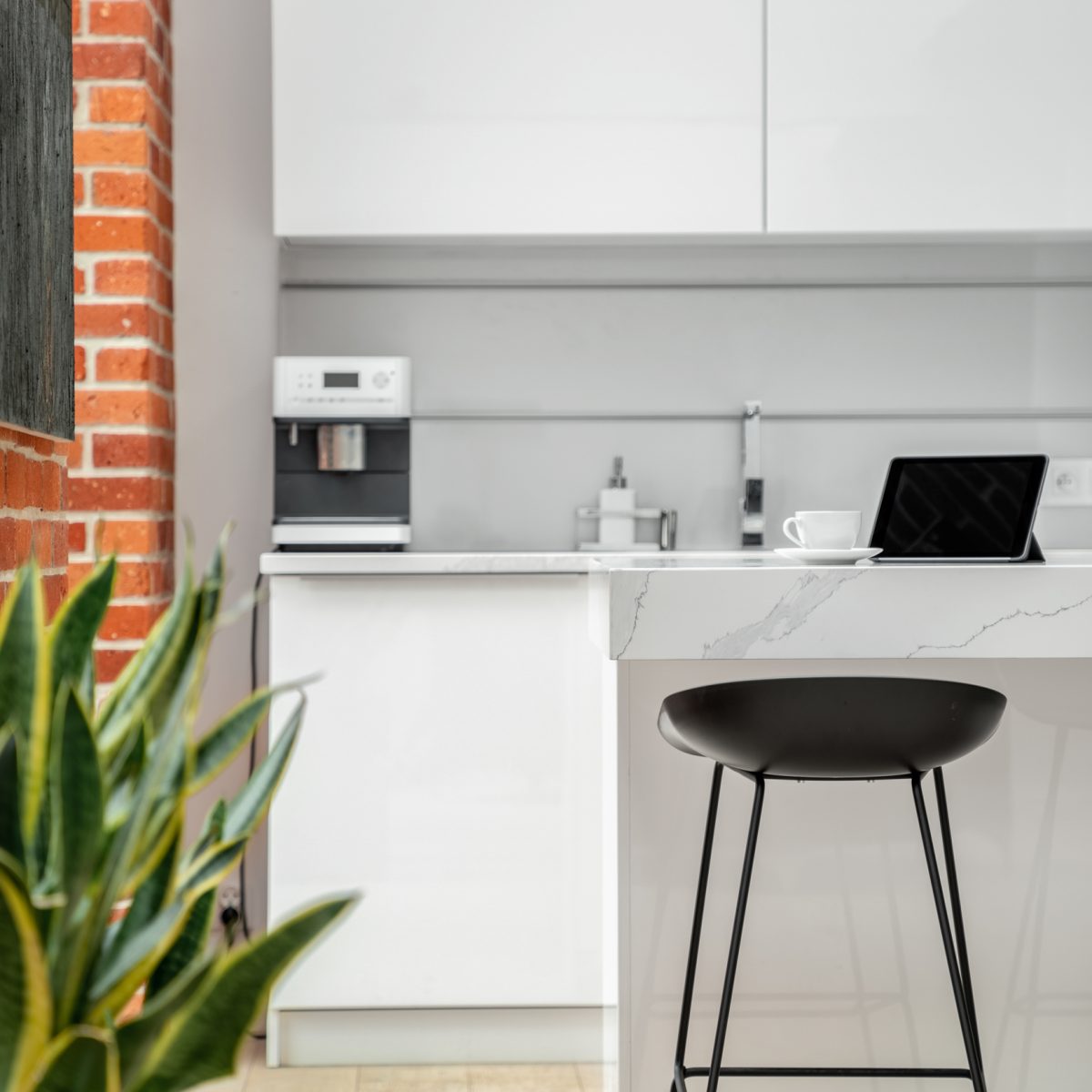 Black chair in white kitchen