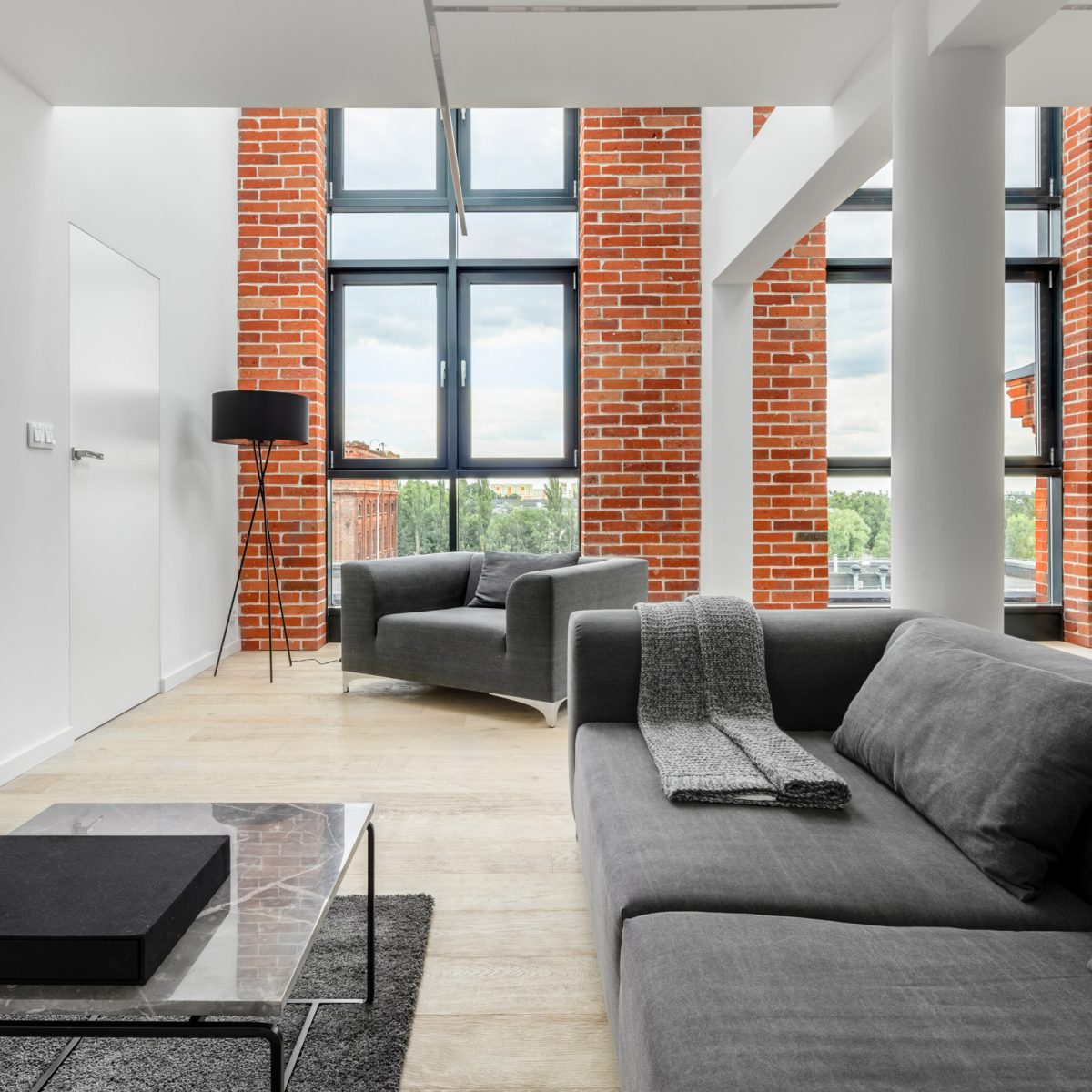 Living room in loft apartment with brick wall