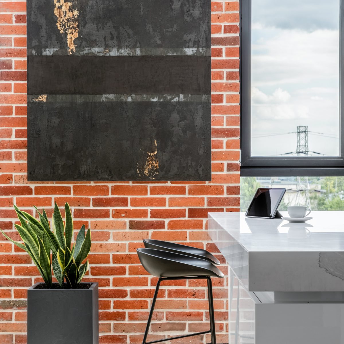 Exposed red brick on kitchen wall