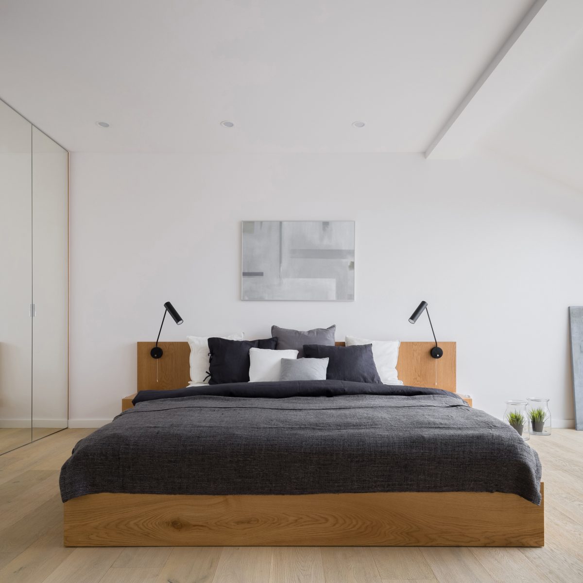 Modern attic bedroom with mirrored wardrobe