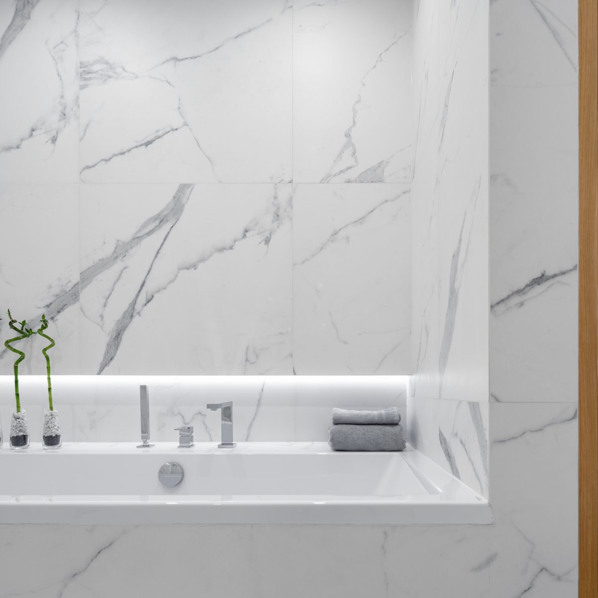 Bathtub in bathroom with marble tiles